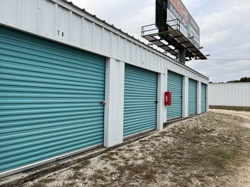 Close-up of storage units with teal roll-up doors at Pipe Creek location